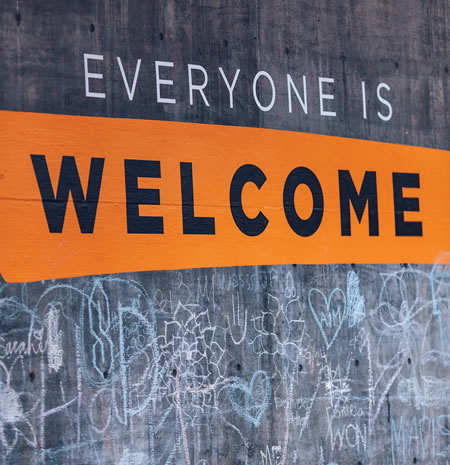 School blackboard with sign that says Everyone is Welcome