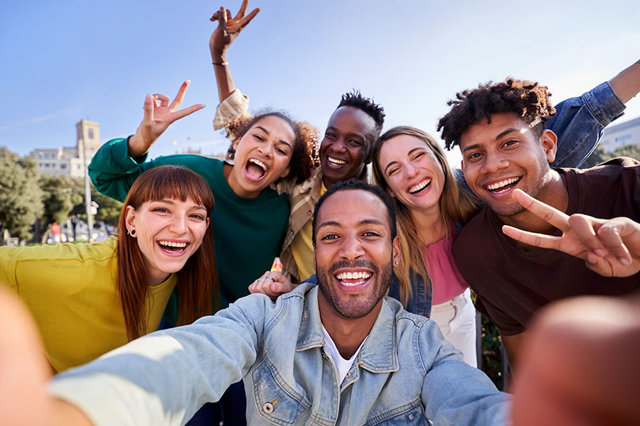 Young adults smiling and gesturing the peace sign