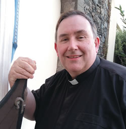 Fr. Philip Gillespie beside the "oar-less coracle"