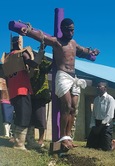 "Jesus" hoisted on the cross