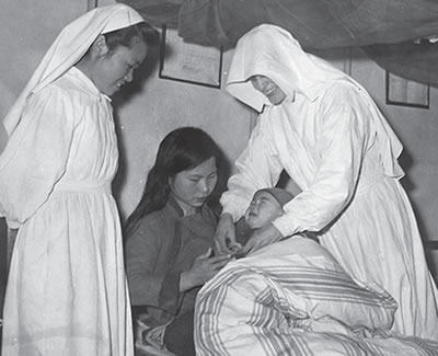 Columban Sisters helping with sick baby