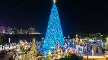 Christmas tree and decoration with skyline of Victoria harbor of Hong Kong city