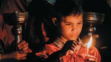 Child lighting a candle