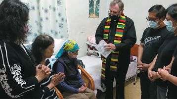 Fr. Larry Barnett with Granny MaHong, seated wearing head scarf