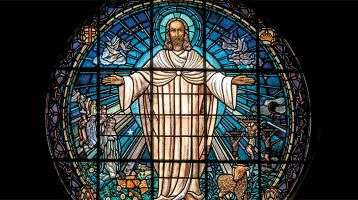 Stained glass window of a compassionate Jesus 