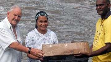 Carrying the altar cloth after the trip across the river