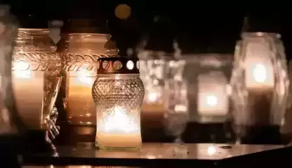 candles burn in a memorial to the deceased