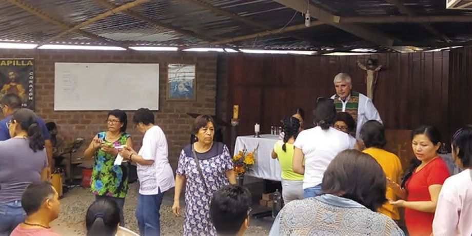 Columban Fr. Ed O’Connell and parishioners before Mass