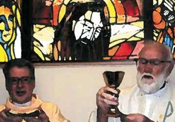 Columban Frs. Barry Cairns (right) and Leo Schumaker (left) in front of the window
