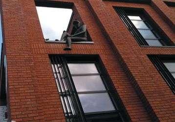 A Peaky Blinders statue on a building