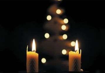 lit candles in a darkened church