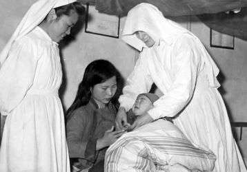 Two Sisters helping a mother with her baby in China