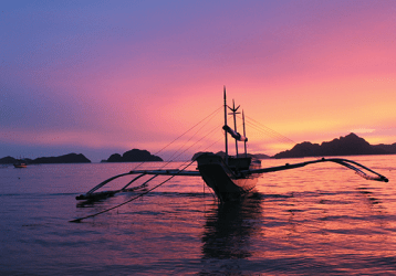 canoe on the water at sunset