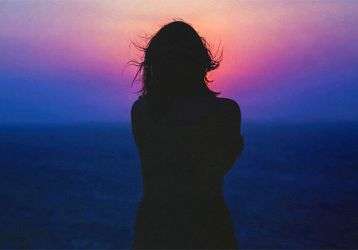 Woman staring into the sunset